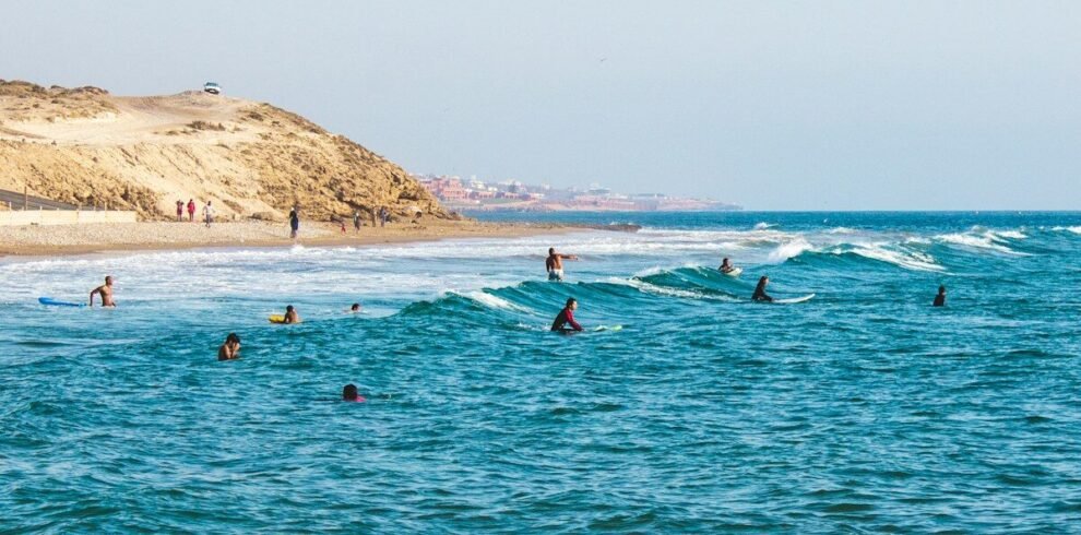people riding surfboards in ocean at daytime