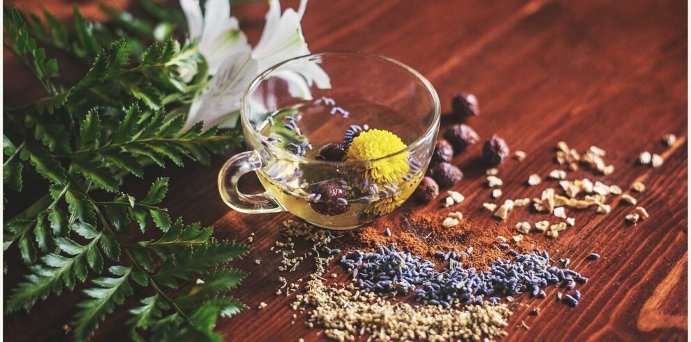 clear tea cup on brown surface
