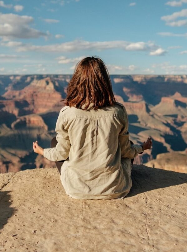 woman sitting on hill