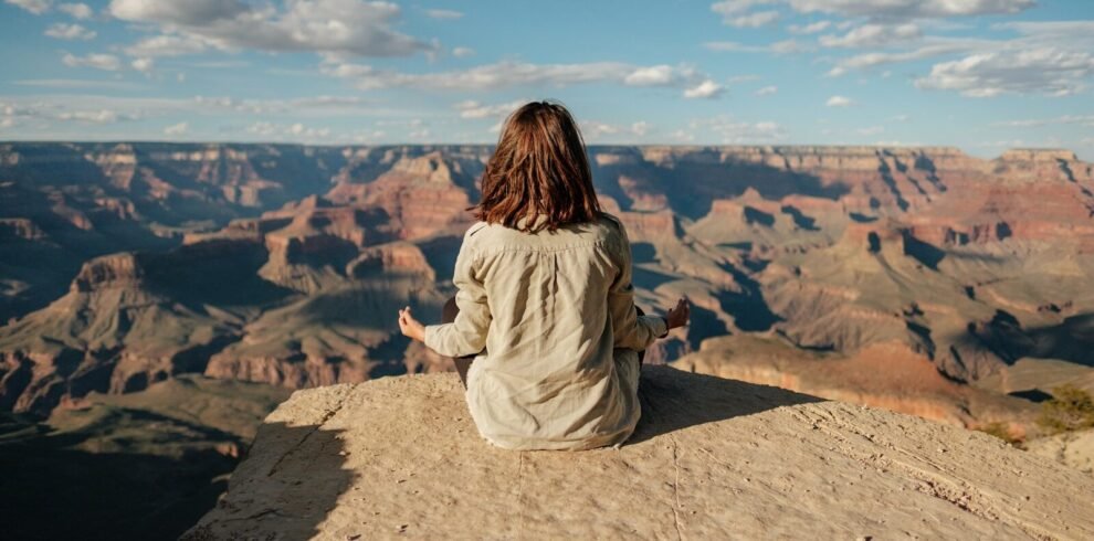 woman sitting on hill