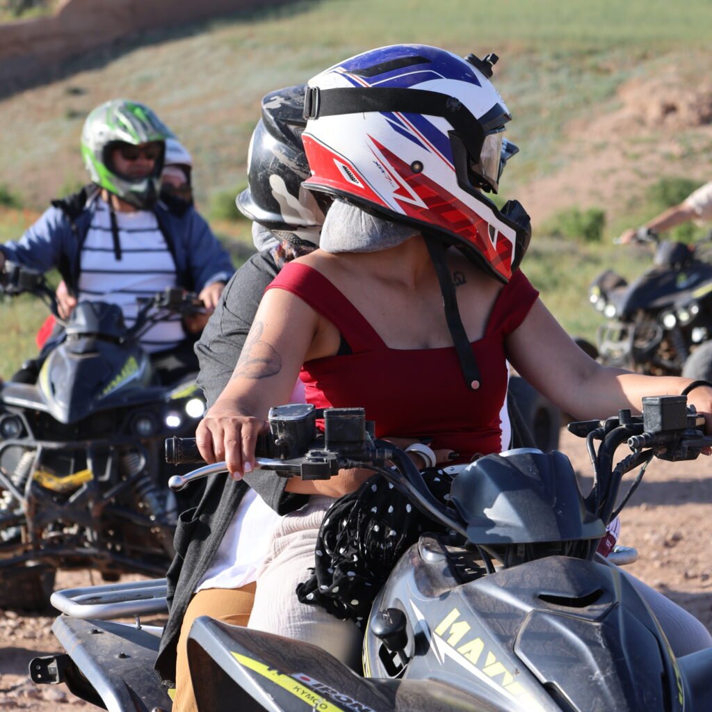 Traveler driving an ATV quad bike on an outdoor trail during a Moroccan desert excursion