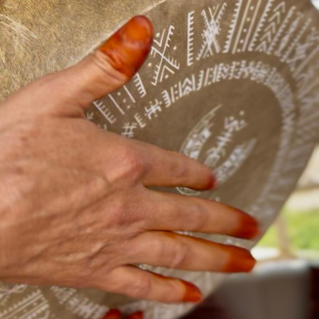 Henna hands on decorative drum