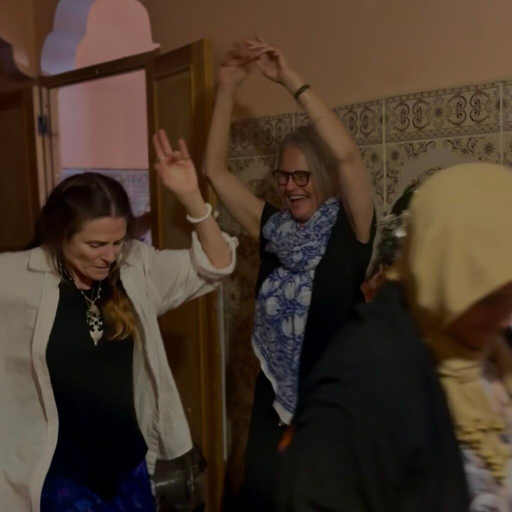 Women dancing joyfully in celebration.