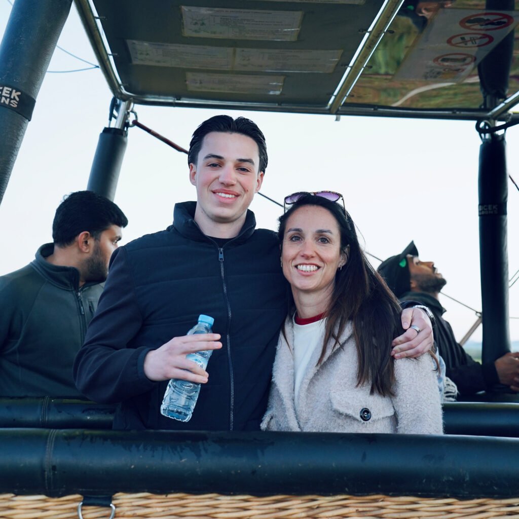 Happy couple posing inside a hot air balloon basket during an excursion in Morocco