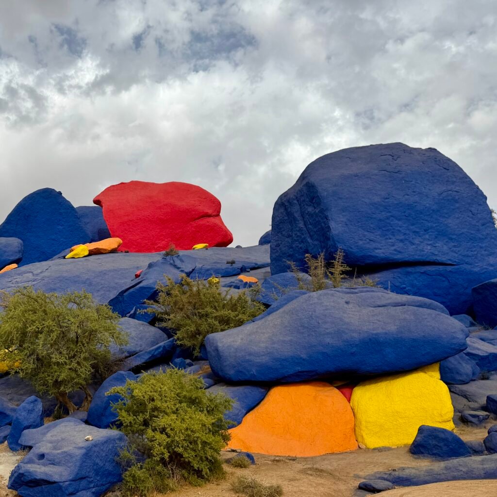 Vibrant painted rocks artwork created by Jean-Verame in the desert landscape of Tafraoute, Morocco