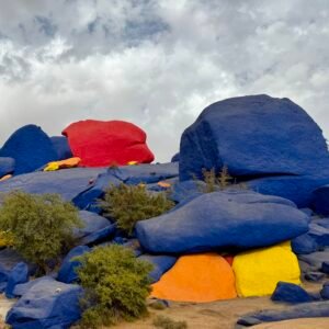 Vibrant painted rocks artwork created by Jean-Verame in the desert landscape of Tafraoute, Morocco