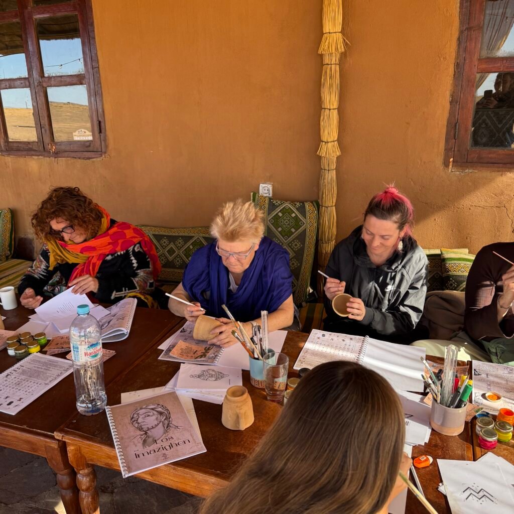 People painting pottery in Morocco workshop.