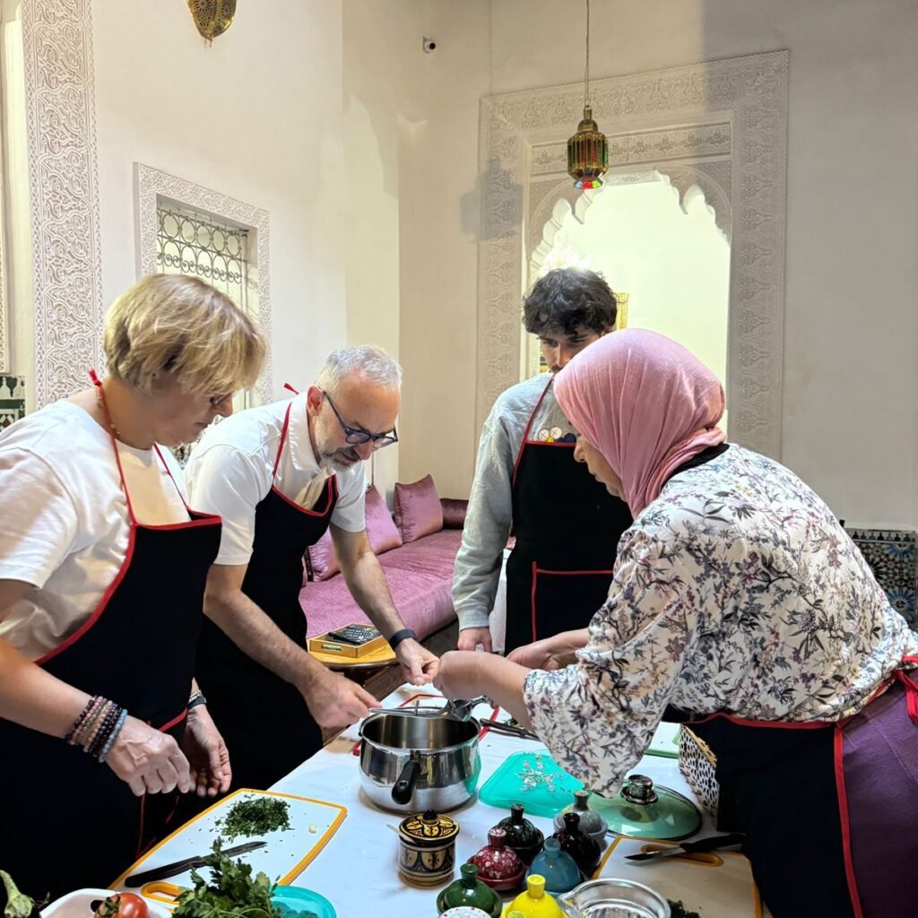 Travelers and a local instructor working together at a kitchen counter with fresh ingredients during a cooking class